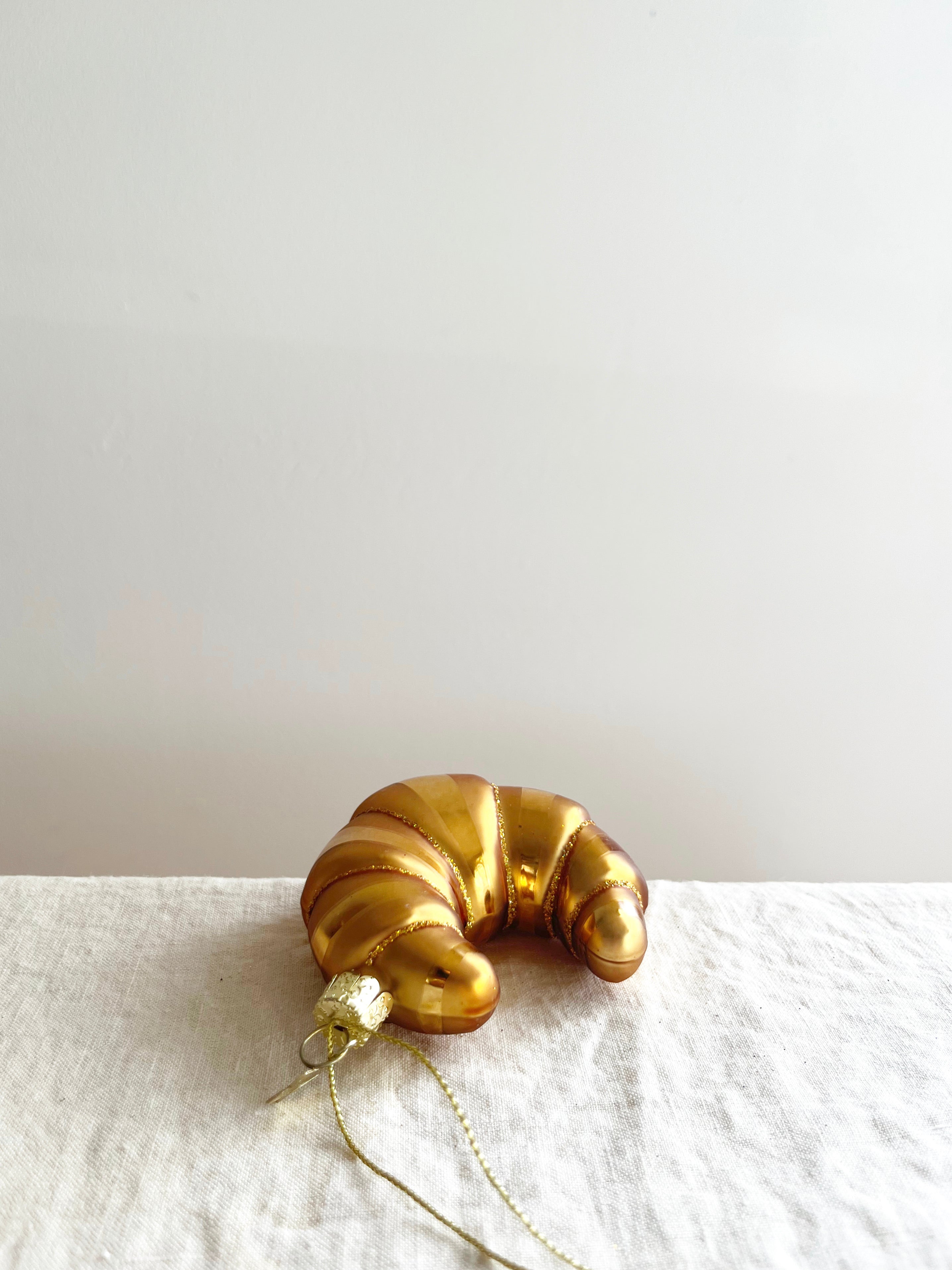 glass christmas ornament shaped like croissant