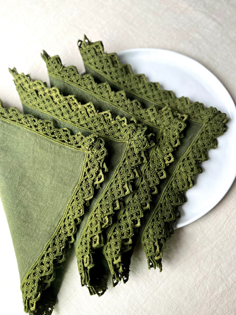 green linen napkins with macrame trim folded