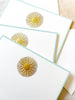 The Printery Sun Medallion Note Cards white with gold sun and beveled aqua edge 6.25 by 4.5 inches fanned out on table