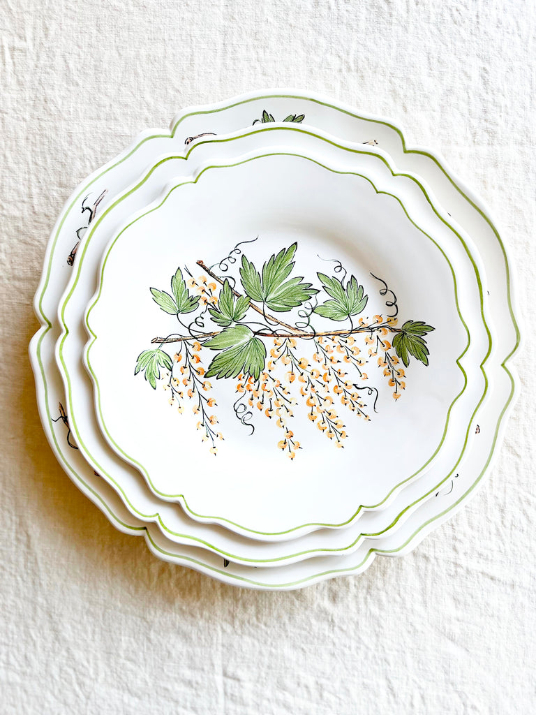 charger plate with green leaves and currants stacked