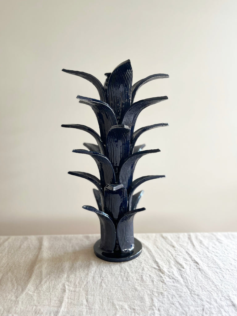 blue taper candle holder shaped like the top of a pineapple 16.6 inches tall