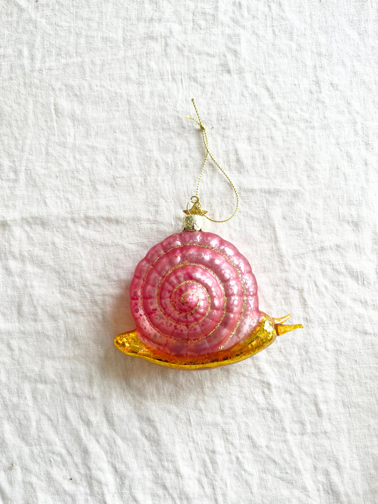 pink and gold snail glass christmas ornament with gold ribbon