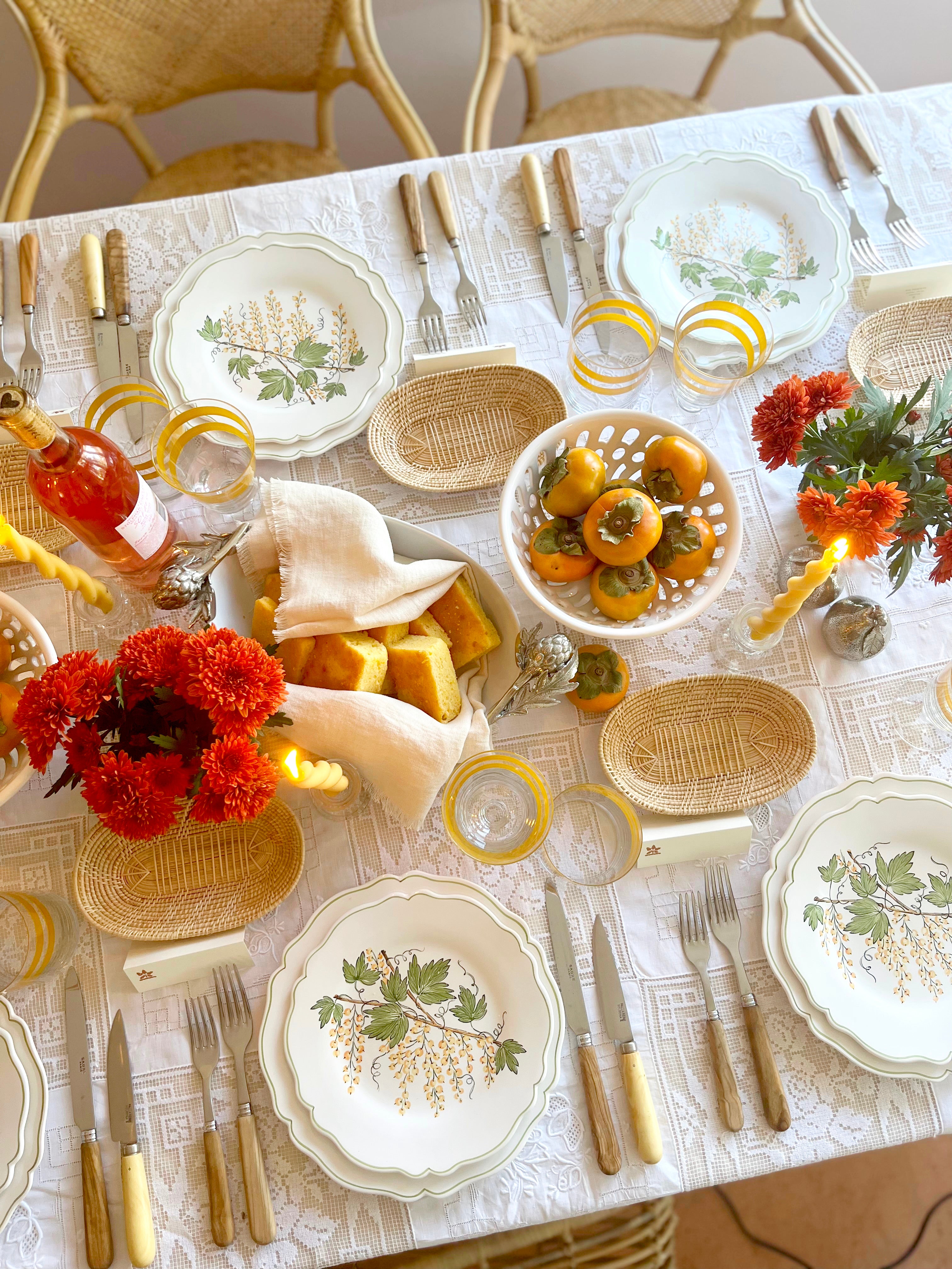 serving platter with green leaves and currants with placesettings