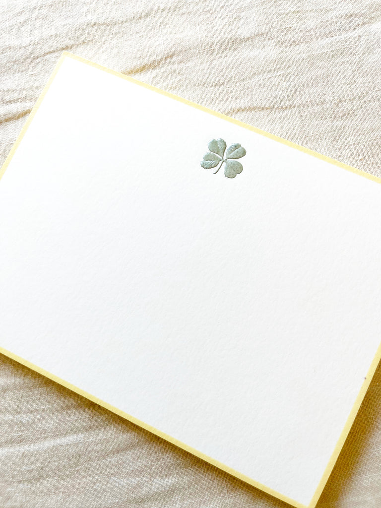 The Printery Four Leaf Clover Note Cards white with green four leaf clover and yellow edge 6.25 by 4.5 inches on white table