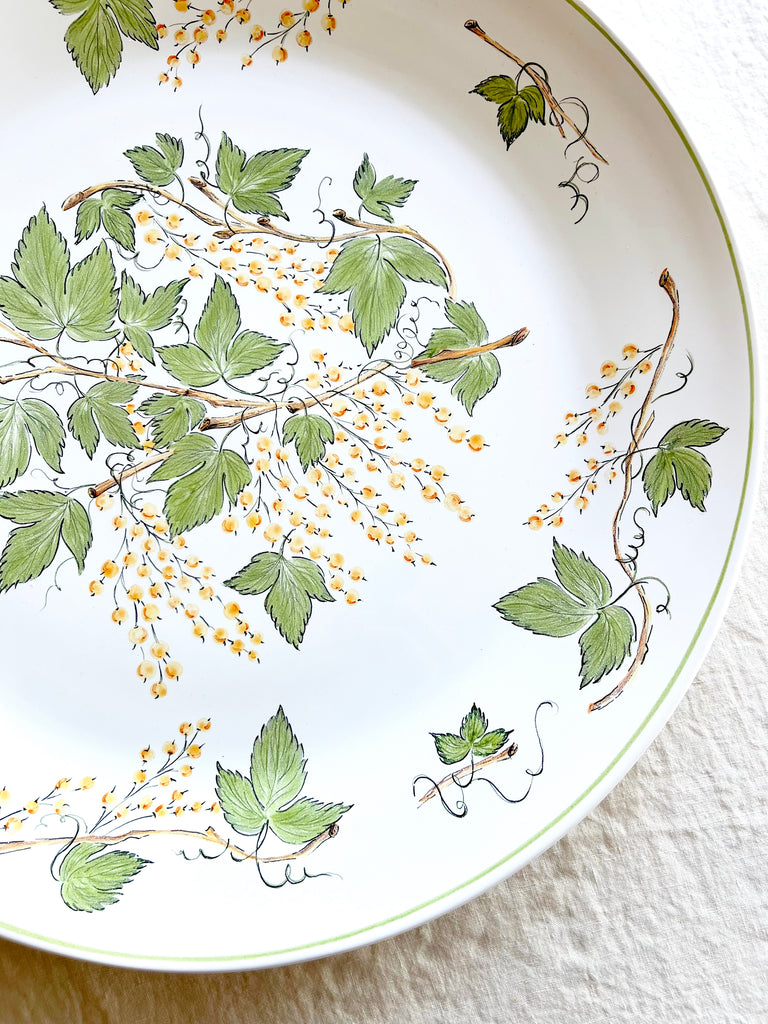 serving platter with green leaves and currants detail view