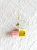 pink and gold glass christmas ornament shaped like a capsule with chill pill written on side