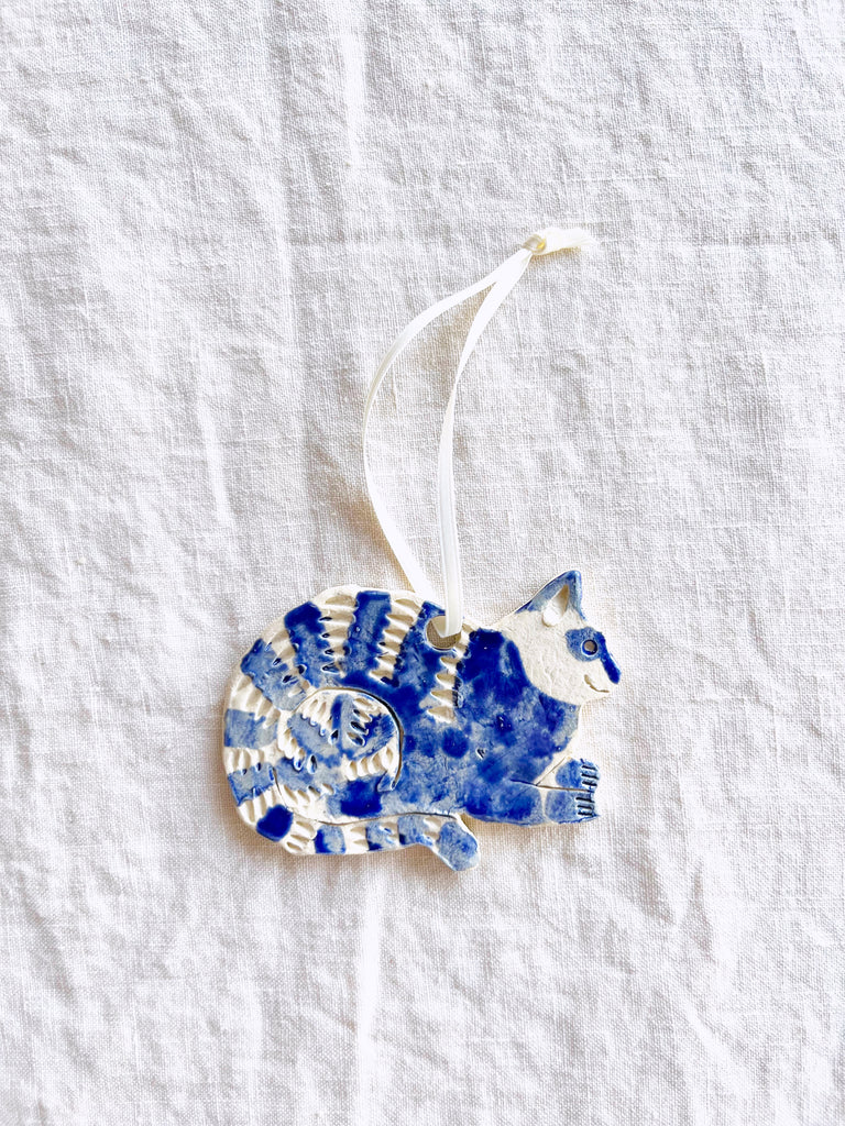 hand painted blue and white cat christmas ornament with white ribbon
