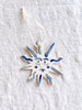 hand painted blue and white star christmas ornaments on linen tablecloth