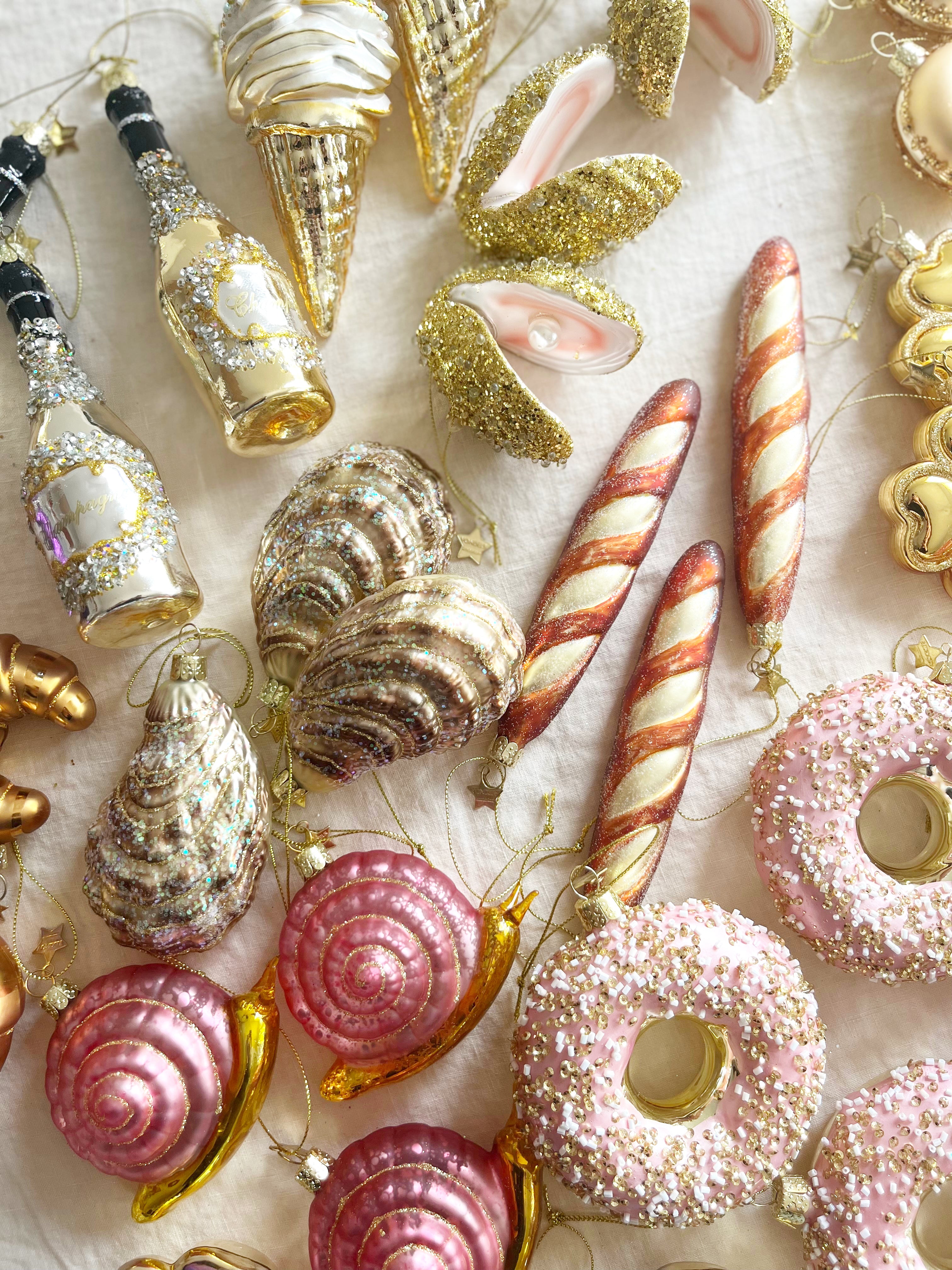 glass christmas ornament shaped like french baguette in group with other ornaments