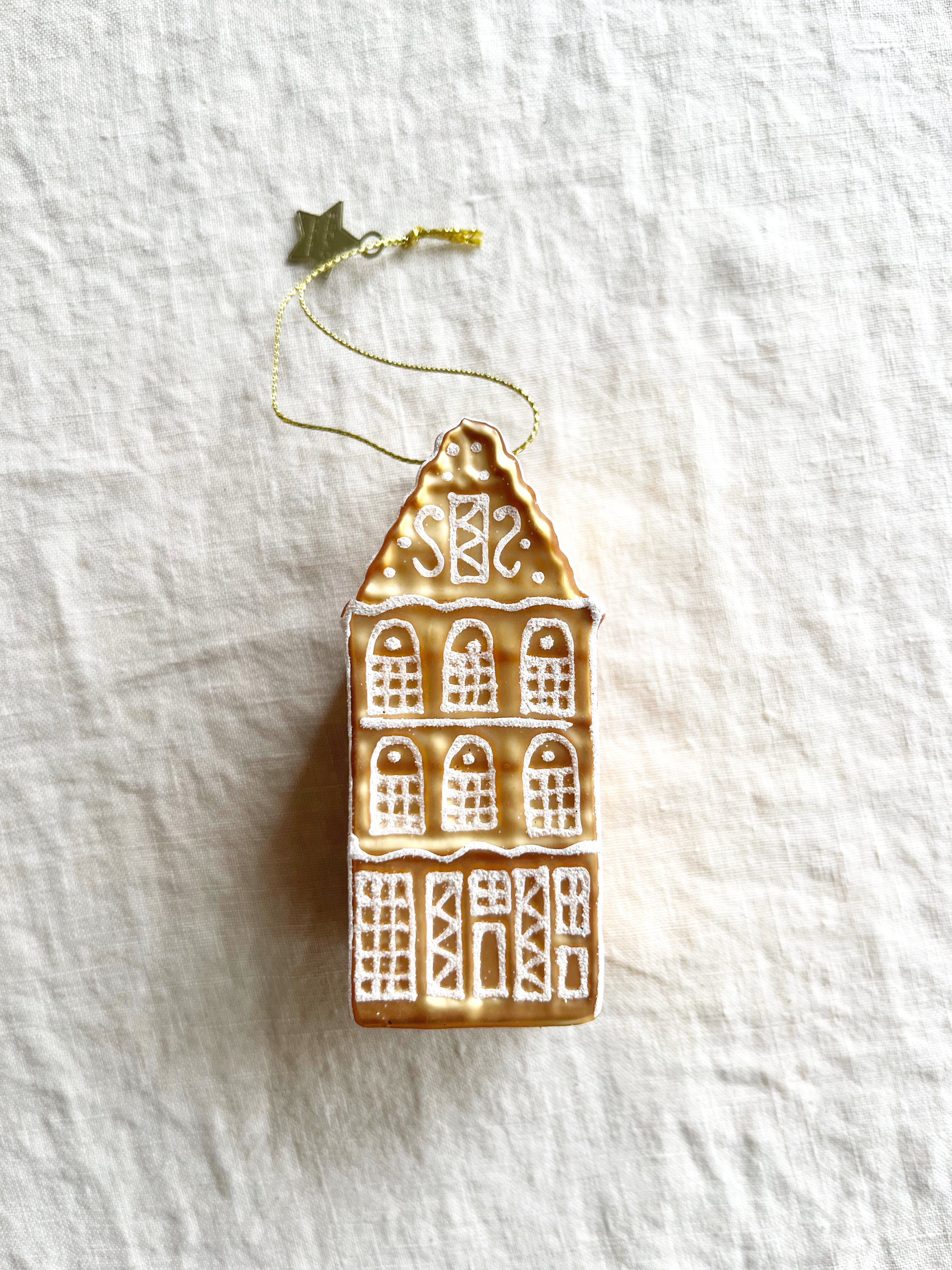 glass christmas ornament shaped like gingerbread house