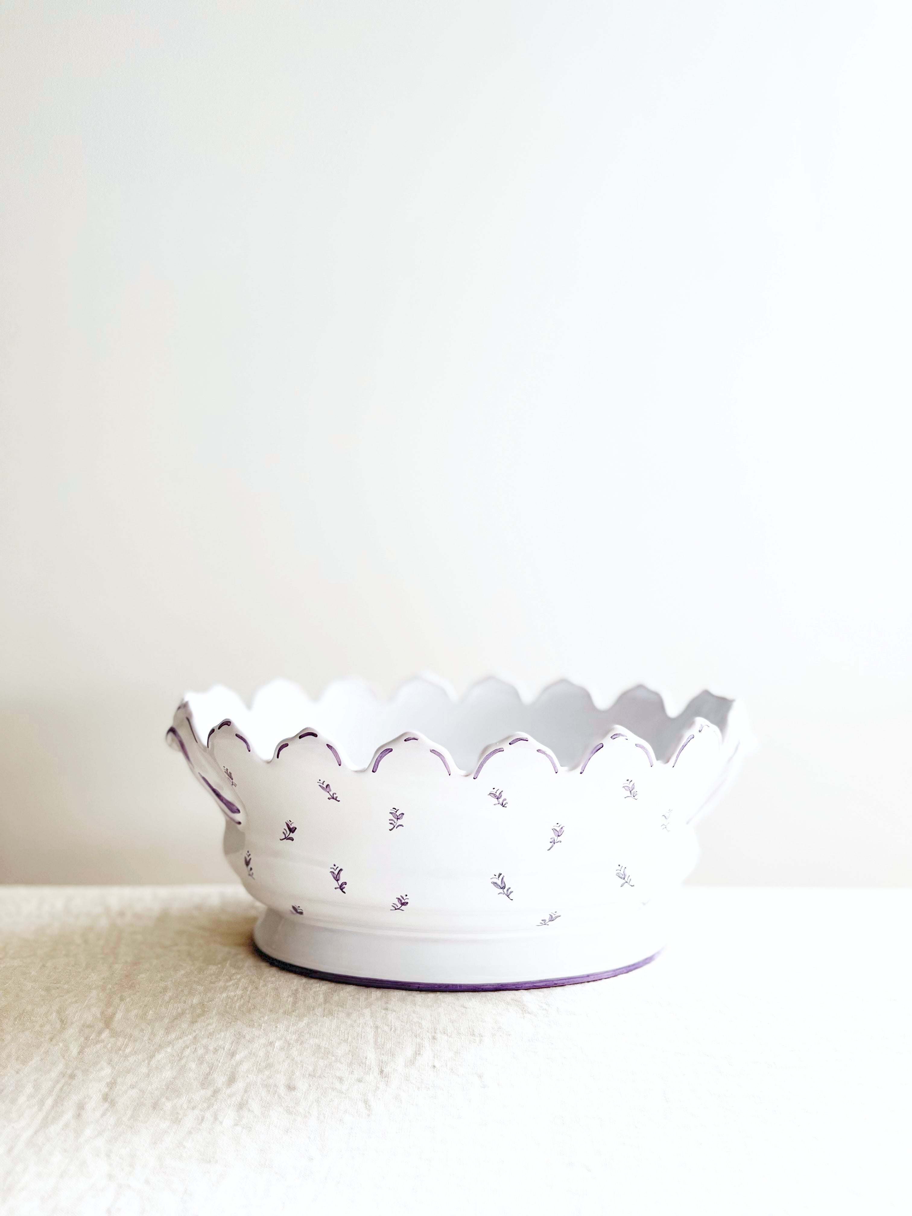 purple and white jardiniere planter on white table