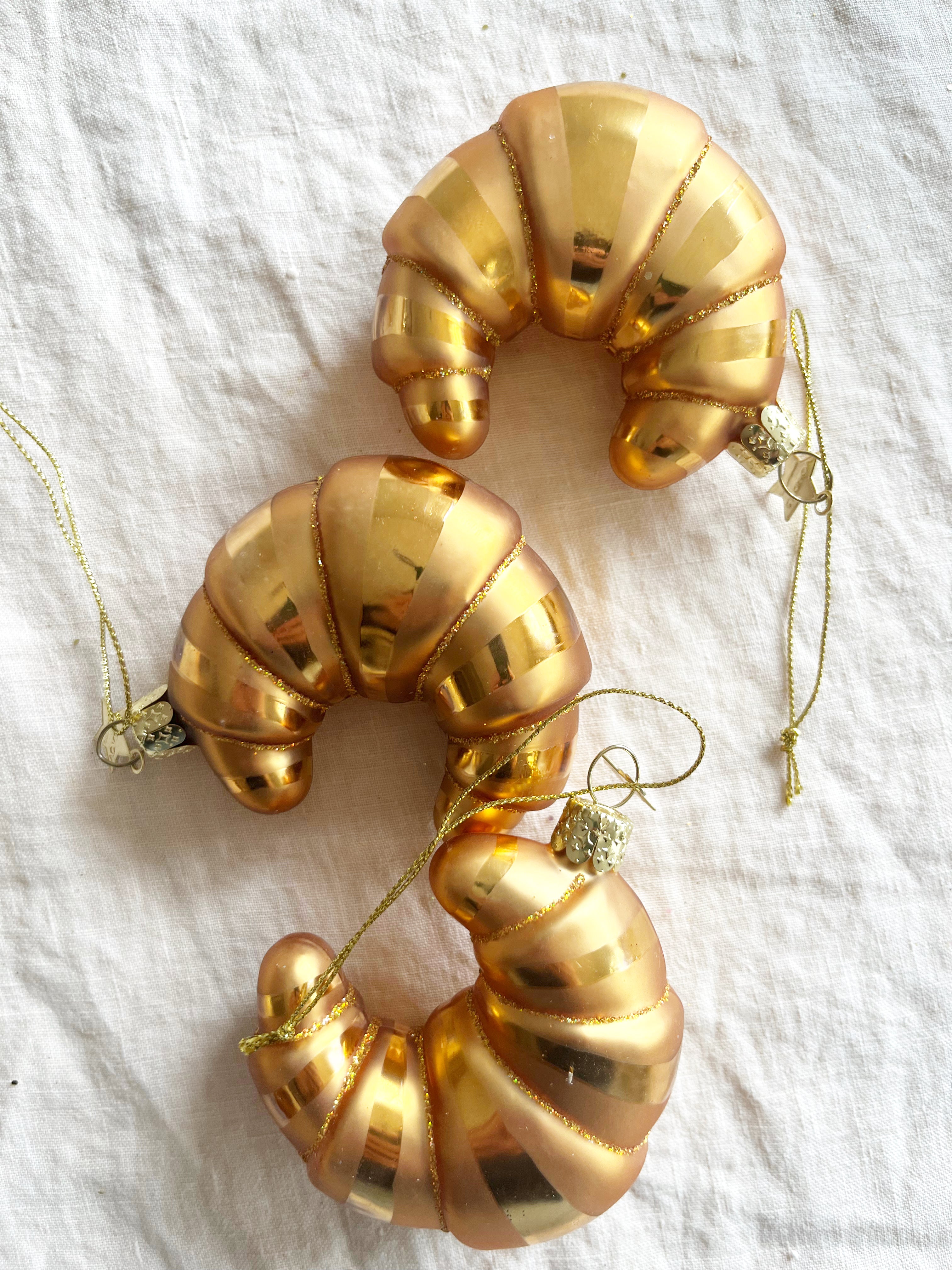 glass christmas ornament shaped like croissant in group of three