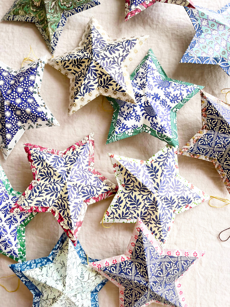 star shaped paper christmas ornaments in shades of blue