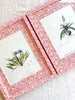 red and white chintz print paper wrapped frame and mat with blue botanical print 12" by 15" on white table