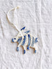 blue and white hand painted christmas ornament in shape of rabbit detail view