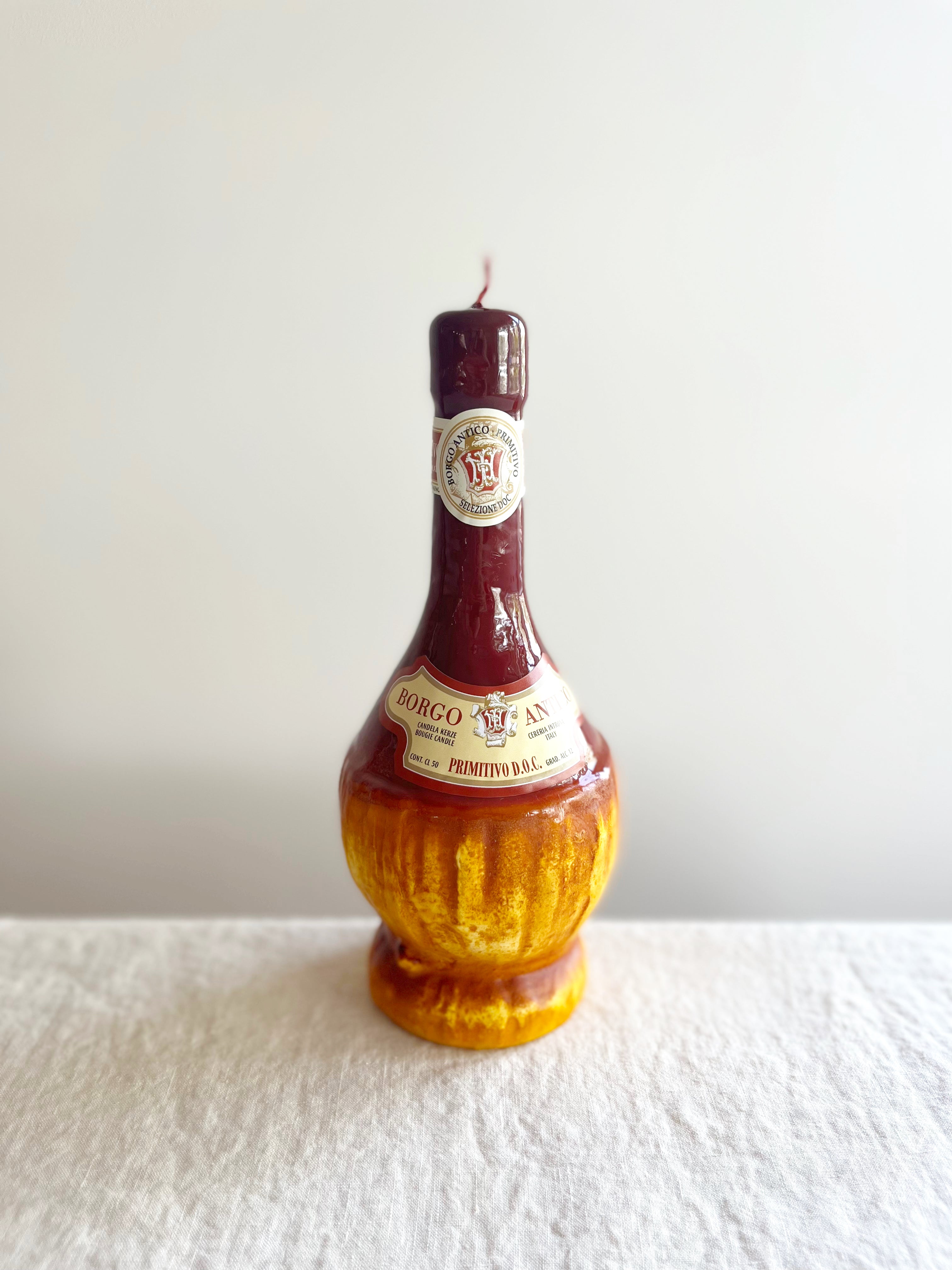 wine bottle shaped candles red on white linen fiaschetto vino