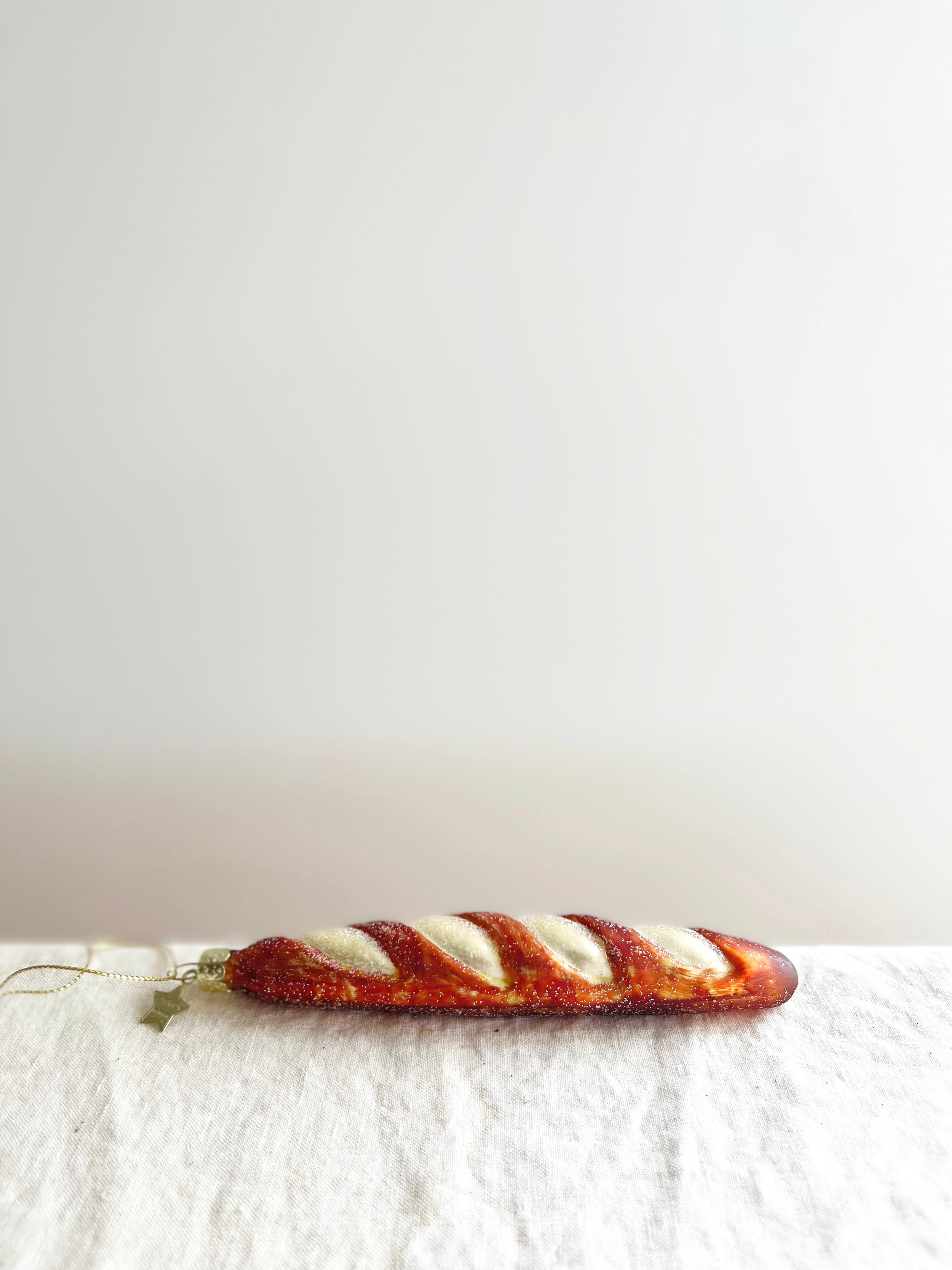 glass christmas ornament shaped like french baguette side view