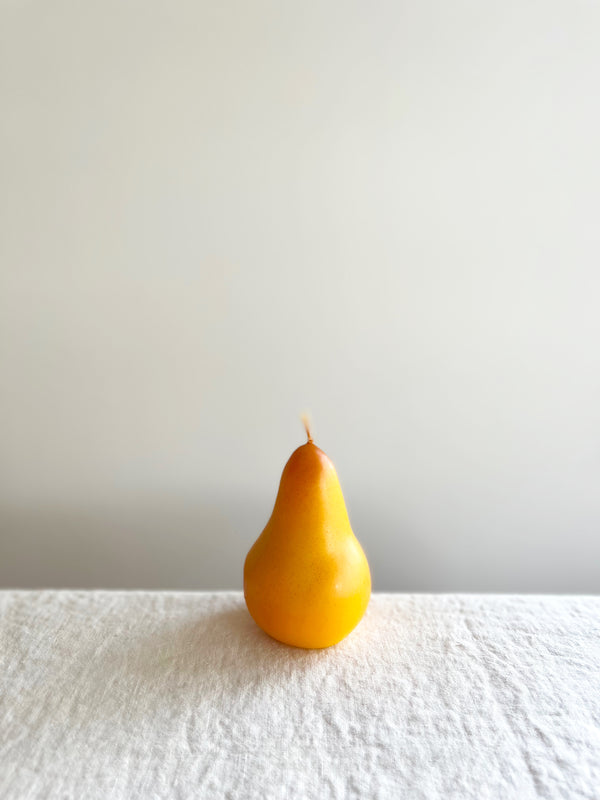 cereria introna pear shaped paraffin candle on white table