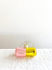 pink and gold glass christmas ornament shaped like a capsule with chill pill written on side side view