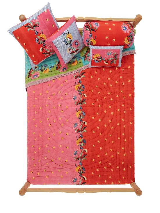 Small Indonesian Red Rose Pillow show in a bedding set
