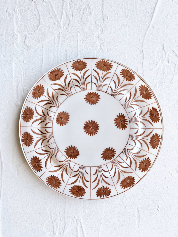 white ceramic dinner plate with brown daisy pattern