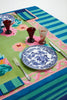 green and blue striped cotton tablecloth with navy border and roses in center 70" by 138" with placesetting