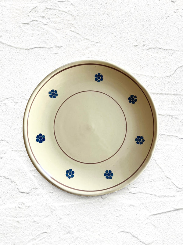 hand painted salad plate with brown rim and blue flowers around edge