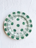 ceramic dinner plate with green daisy pattern