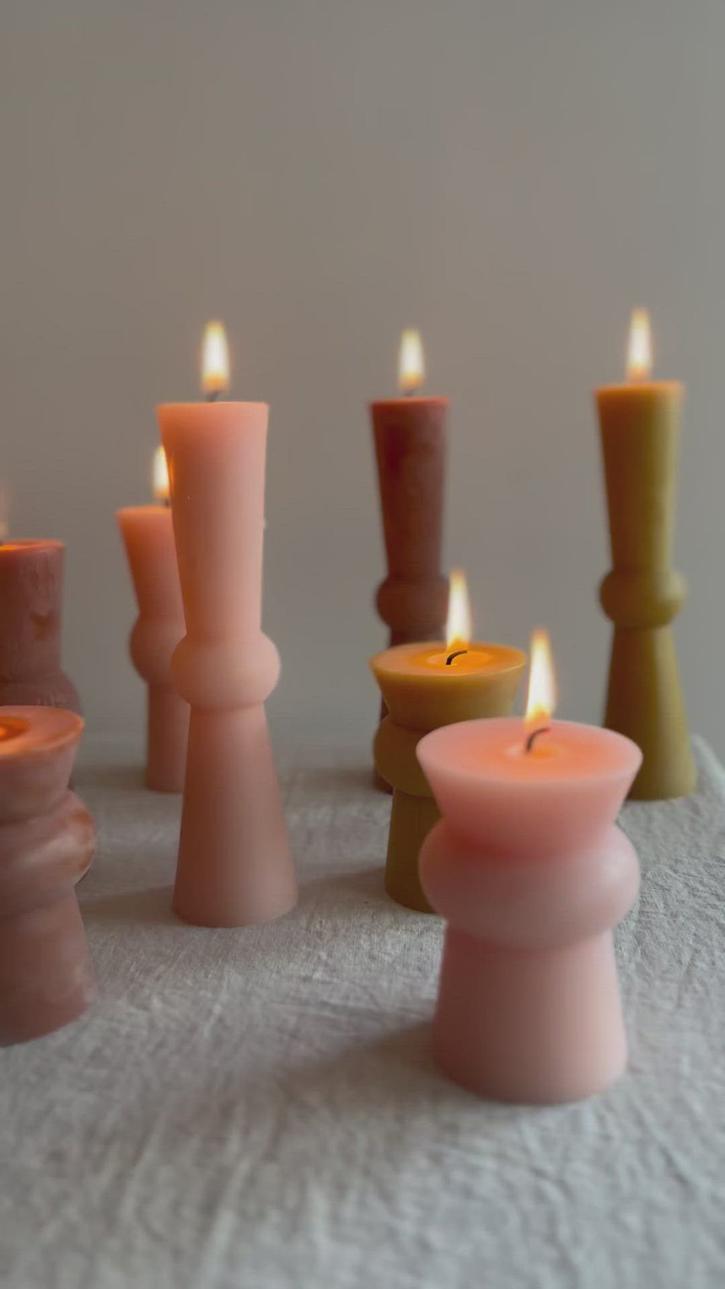 video of assorted totem candles on table with flames lit