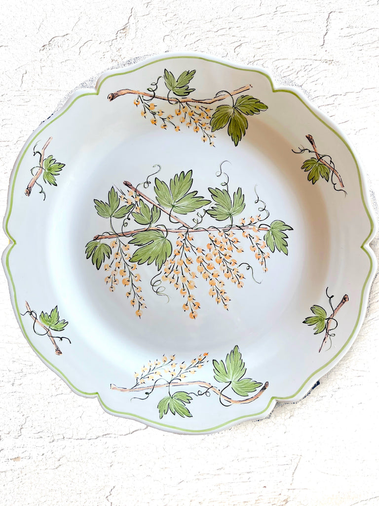 charger plate with green leaves and currants