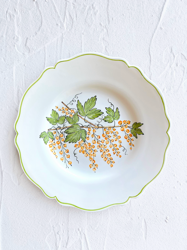 dinner plate with green leaves and currants