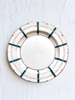 ceramic dinner plate with teal stripes around edge