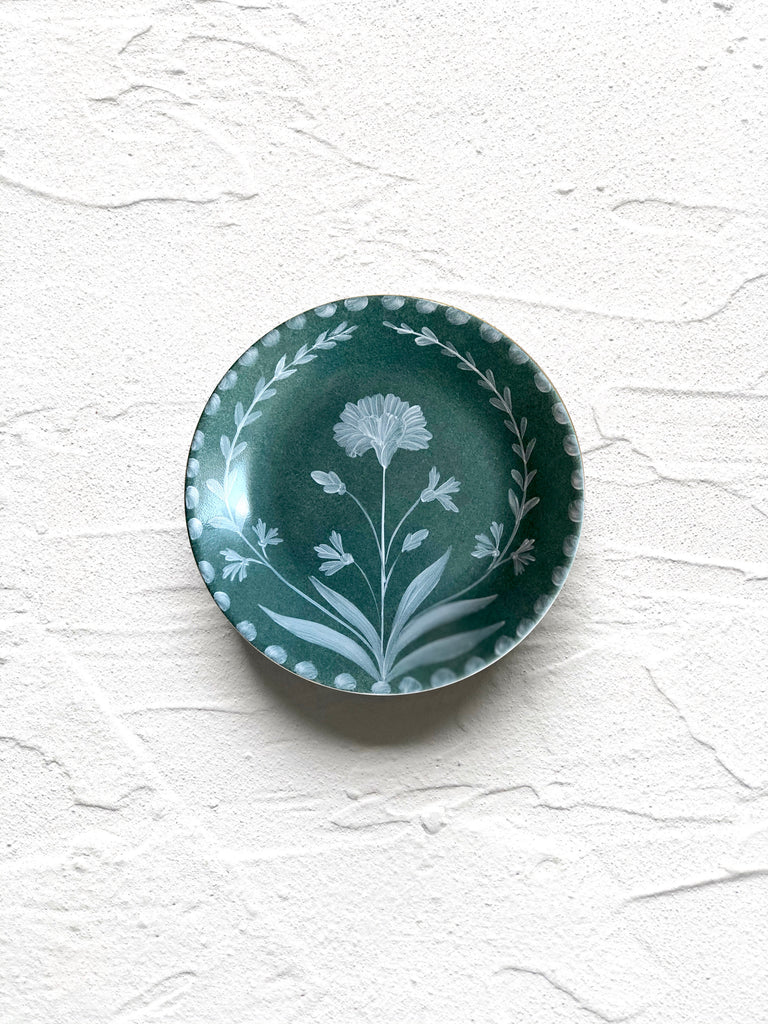 green bread plate with hand painted white floral design