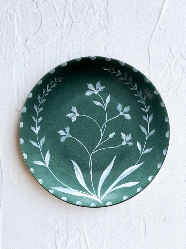 green dinner plate with hand painted white floral design