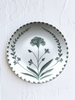 white porcelain dinner plate with green floral pattern