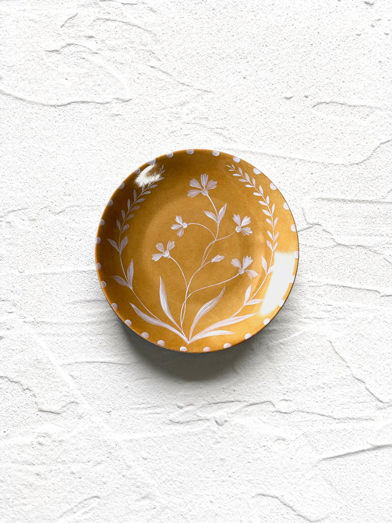 yellow bread plate with white floral pattern