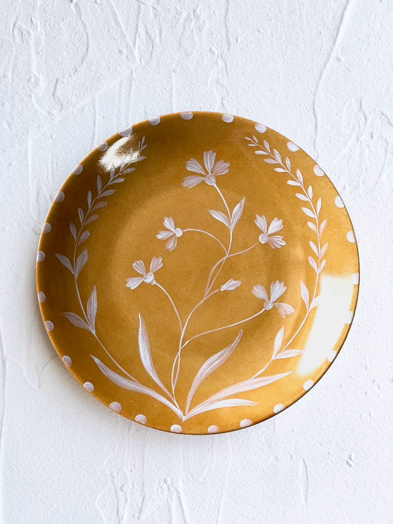 yellow dinner plate with white floral pattern