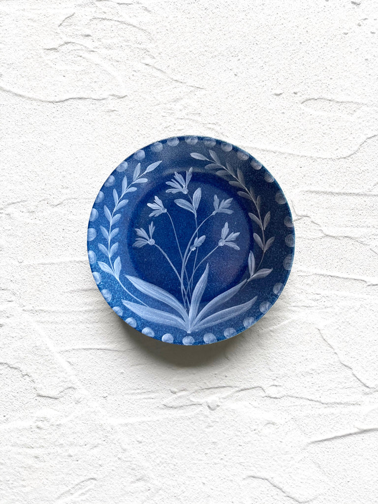 blue bread plate with hand painted white floral design