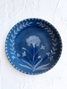 blue dinner plate with hand painted white floral design