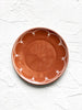 brown salad plate with white scallop design on rim