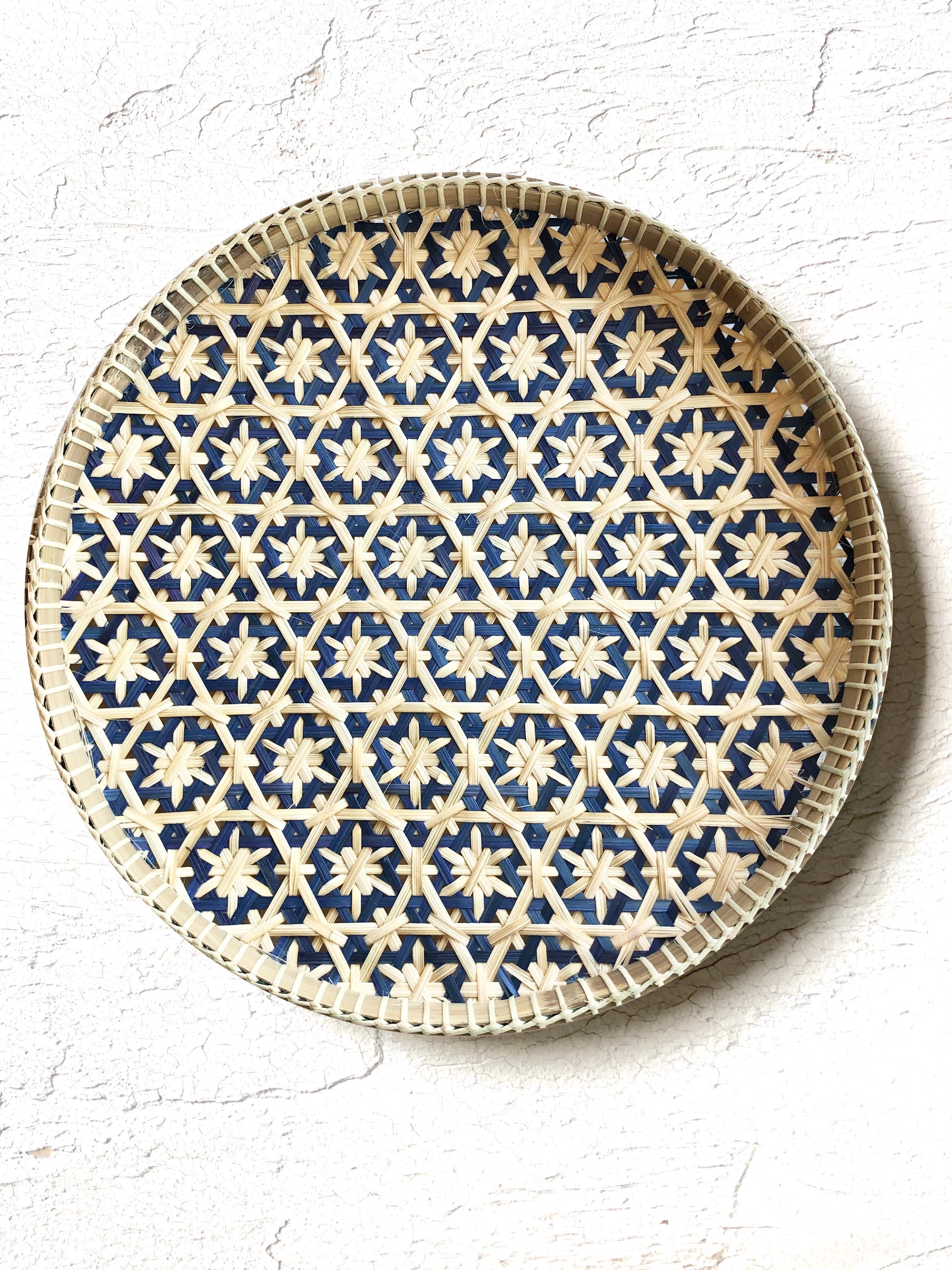 light tan woven tray with navy blue mosaic star pattern 12 inches on white table