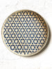 light tan woven tray with navy blue mosaic star pattern 12 inches on white table