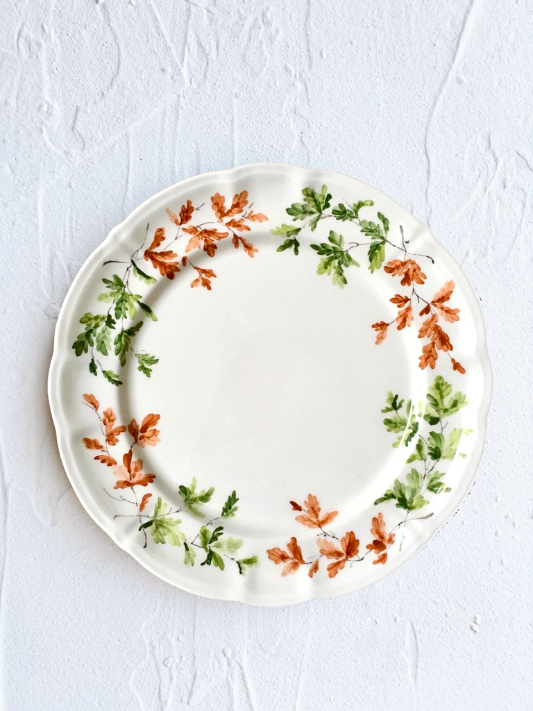 dinner plate with green and orange leaves on rim