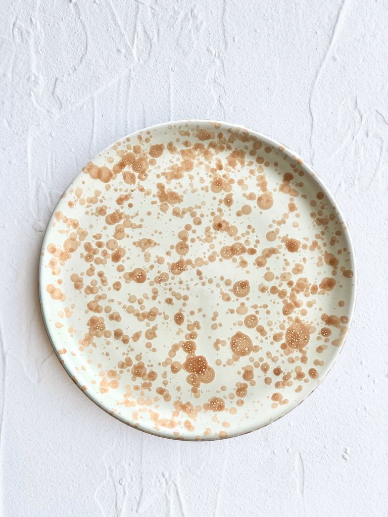 cream fasano dinner plate with light brown speckle pattern
