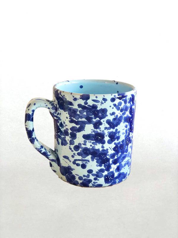 white fasano mug with blue splatter pattern detail view