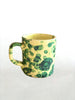 cream mug with green splatter pattern detail view
