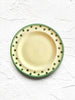hand painted salad plate with green rim and dots around edge