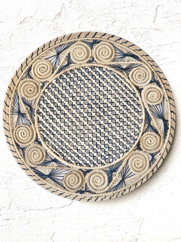 light brown and navy blue woven charger made from seagrass 12.5 inches in diameter